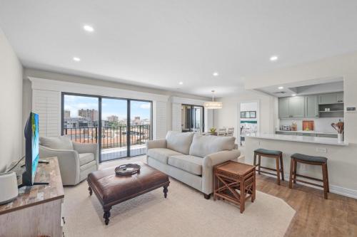a living room with a couch and a table at Rare desirable unit located in Shipps Landing III in Marco Island