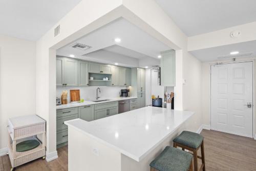 a white kitchen with a large white counter top at Rare desirable unit located in Shipps Landing III in Marco Island