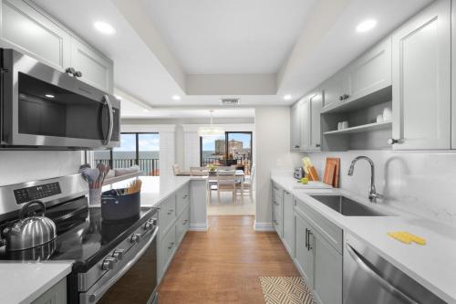 a kitchen with white cabinets and a large counter top at Rare desirable unit located in Shipps Landing III in Marco Island