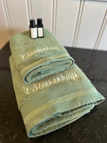 two towels sitting on a table in a bathroom at 't Steenenhuys in Dilsen-Stokkem