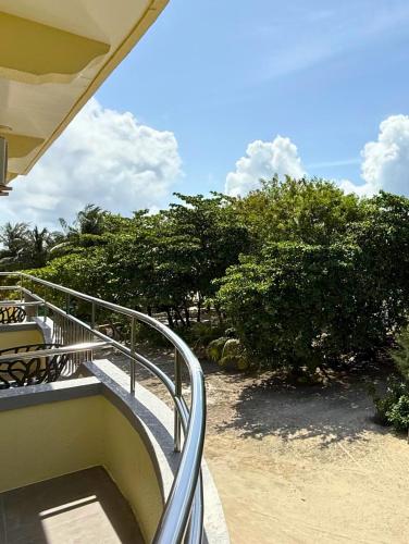 a stairway leading to a balcony with trees at Noah Private Beach House in Himmafushi