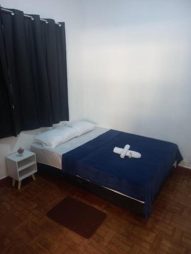 a bedroom with a bed with two crosses on it at Pousada no Centro de Taubaté in Taubaté