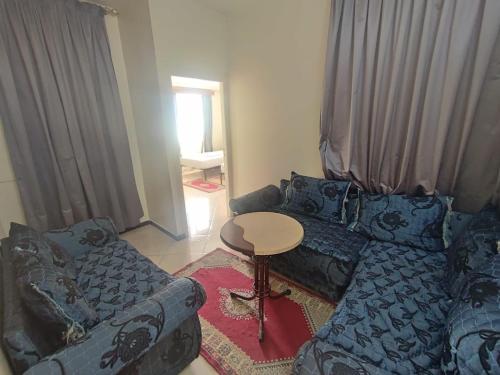 a living room with a couch and a table at Perla Hôtel in Fès