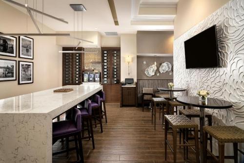 a restaurant with a bar with purple bar stools at Victoria Marriott Inner Harbour in Victoria