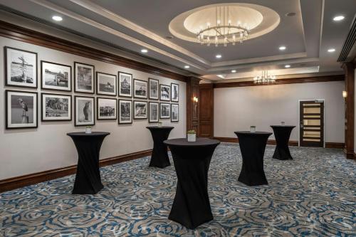 a room with black tables and pictures on the wall at Victoria Marriott Inner Harbour in Victoria