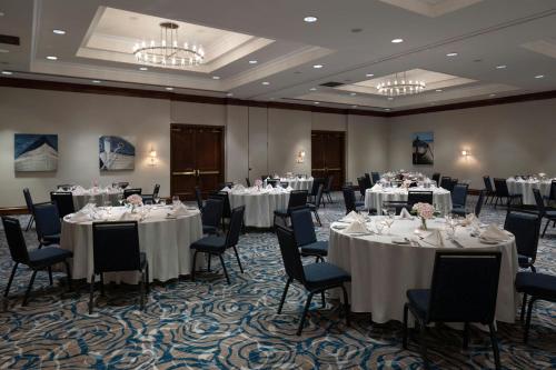 a banquet room with tables and chairs with white tablecloths at Victoria Marriott Inner Harbour in Victoria