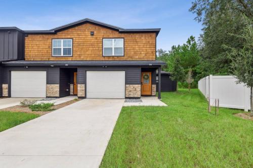 a house with two garage doors in a yard at Isabella Ct Townhome in Orange Park