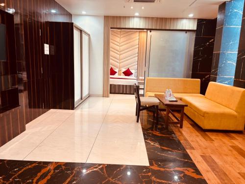 a living room with a couch and a table at Hotel Chariot Inn in Deoghar