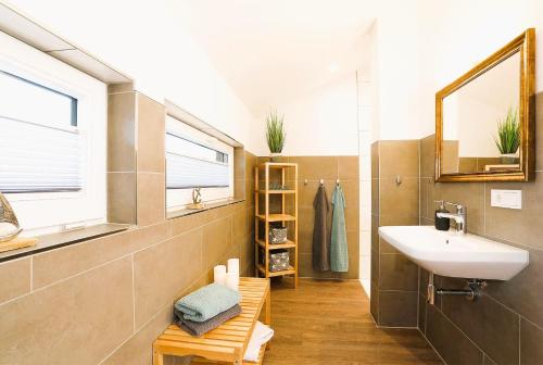 a bathroom with a sink and a mirror at Traumvilla am Müritz Nationalpark, 17 Gäste, Sauna in Boek