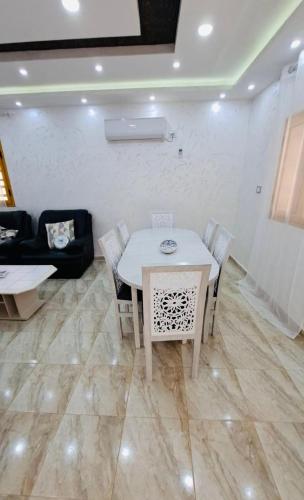 a dining room with a white table and chairs at Villa Dar Rayan & Naelle in Midoun