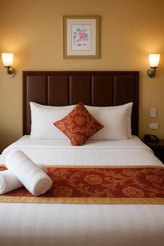 Ένα ή περισσότερα κρεβάτια σε δωμάτιο στο JMM Grand Suites