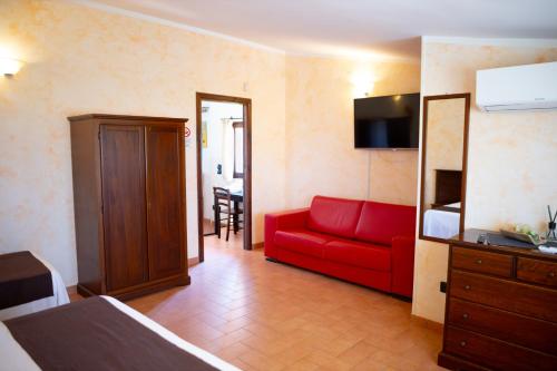 a living room with a red couch in a room at Bed & Breakfast Giardini Di Marzo in Lecce