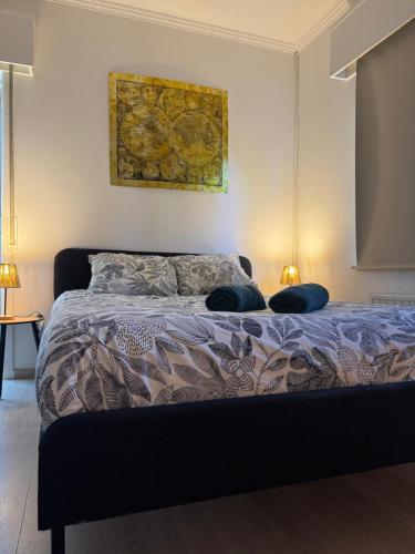 a bedroom with a bed with two pillows on it at Le petit Cocon in Dilbeek