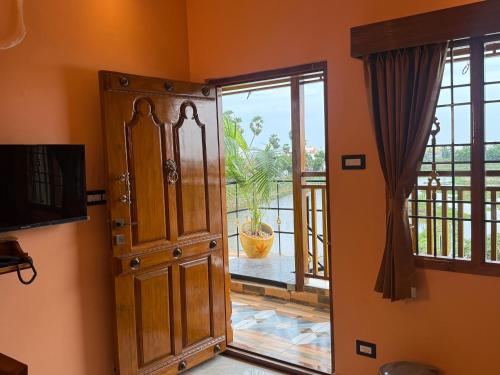 a room with an open door to a balcony at Lake View Residency in Puducherry
