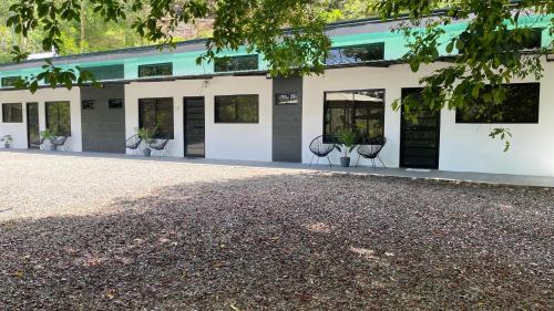 a building with chairs in front of it at Villas Anna Bertha 2 noches minimo in San Isidro