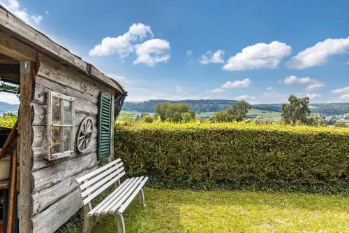a wooden building with a bench in front of it at Gita in Öhningen
