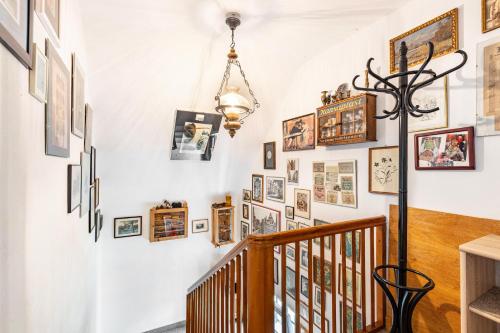 a hallway with a staircase with pictures on the wall at Gita in Öhningen