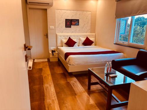 a hotel room with a bed and a couch at Hotel Chariot Inn in Deoghar