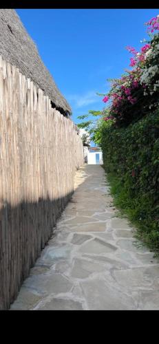 a wooden fence next to a sidewalk next to a fence gmaxwell gmaxwell gmaxwell at Studio Cecile in Malindi