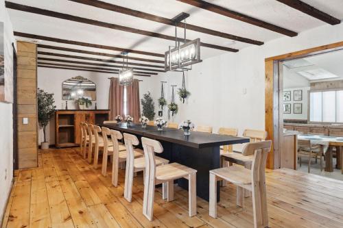 a dining room with a large table and chairs at The birch House Heated Pool, Sauna, Hot Tub & More in Dover