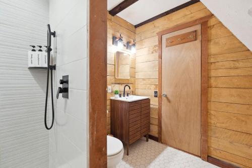 a bathroom with a toilet and a sink at The birch House Heated Pool, Sauna, Hot Tub & More in Dover