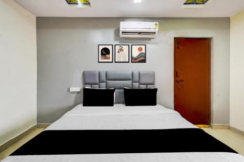 a bedroom with a bed and a air conditioner on the wall at Hotel O 5 Five Star in Upal