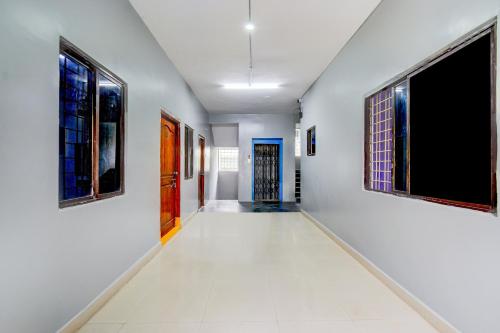 an empty hallway with paintings on the walls at Hotel O 5 Five Star in Upal