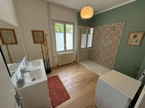 a bathroom with a toilet and a sink and a window at Villa Jeanne in Saint-Nazaire-en-Royans