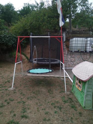 a playground with a trampoline and a dog house at Stefke in Lučani