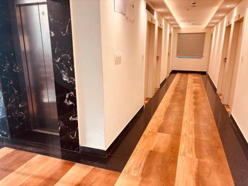 a hallway of an office with wood floors and black walls at Hotel Chariot Inn in Deoghar