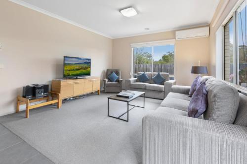 a living room with a couch and a tv at Toonalook Retreat in Paynesville