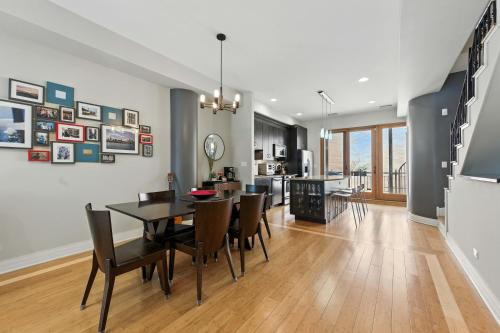 a dining room and living room with a table and chairs at Spacious 3-Bed West Loop Townhouse, 1 Car Garage in Chicago