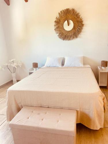 a bedroom with a bed and a mirror on the wall at Gîte Belle Place in Le Gosier