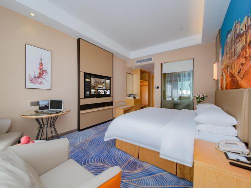 Katil atau katil-katil dalam bilik di Vienna International Hotel Jingzhou New World