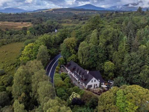 an aerial view of a house in the middle of a forest at Corrieview Lodges in Spean Bridge