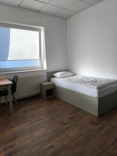 a small bedroom with a bed and a window at Apartamentai1 in Utena