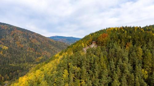 an autumn view of a mountain with trees at chalupa Slunovrat in Hroznětín