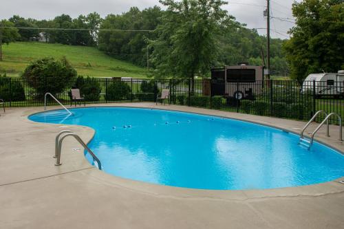 a large blue swimming pool in a park at Cades Cove Landing Condo-Little River Loft in Townsend