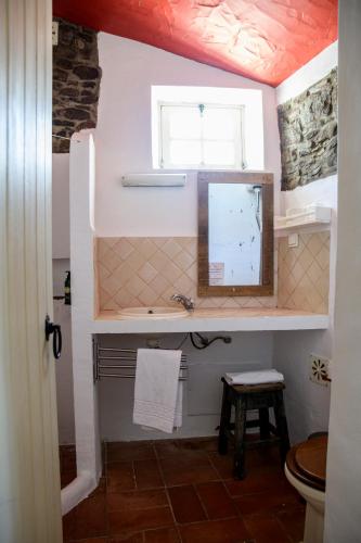 a bathroom with a sink and a window at Aldeia da Pedralva by WOT Signature in Vila do Bispo