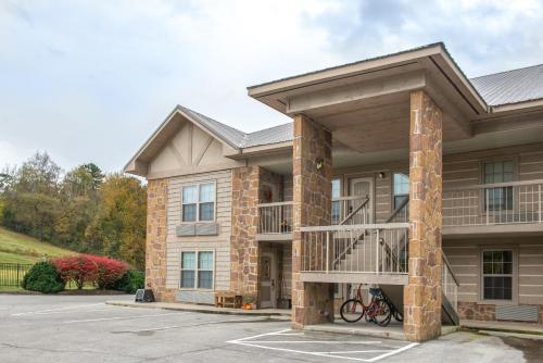 a large apartment building with a balcony at Cades Cove Landing Condo-Little River Loft in Townsend