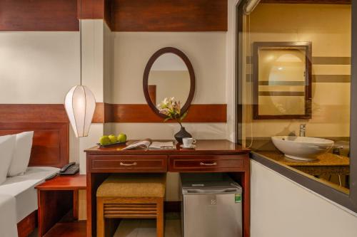a bathroom with a sink and a mirror at NA Hotel Hoi An in Hoi An