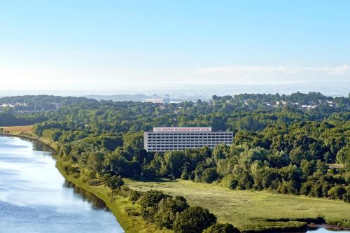 a view of a building next to a river at Muthu Glasgow River Hotel in Erskine