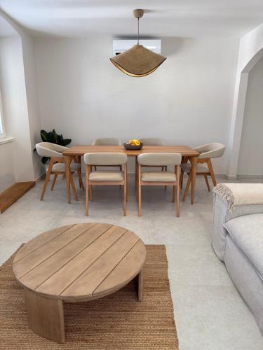a living room with a wooden table and chairs at Apartment Korčula in Korčula
