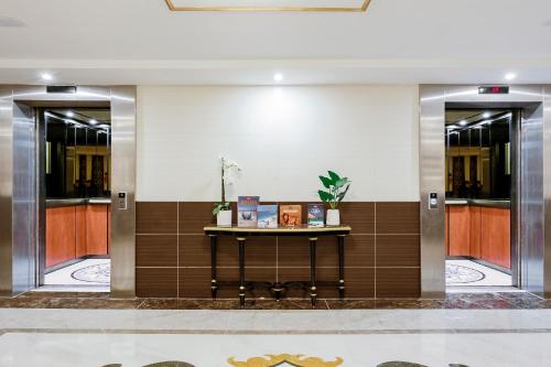 a lobby with a table in a building at Muthu Glasgow River Hotel in Erskine