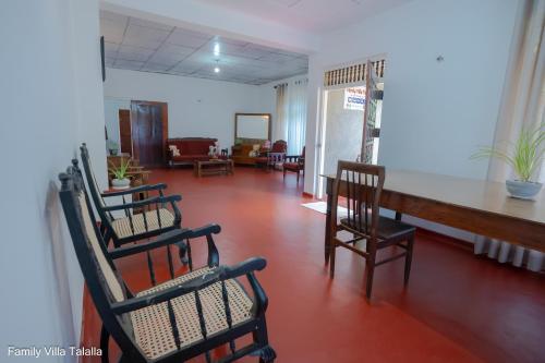 a living room with chairs and a table in it at Family Villa Talalla in Talalla