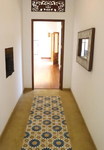 a hallway with a rug on the floor and a door at The Spice House Mirissa in Mirissa