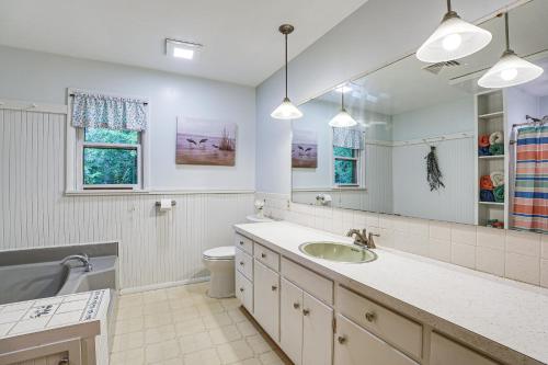 a bathroom with a sink and a toilet and a mirror at Fish, Hike and Golf Countryside Retreat in Bluffton in Bluffton