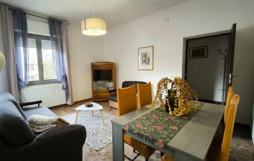 a living room with a table and a couch at Da zia Concetta, casa vacanze immersa nel verde in Colledara