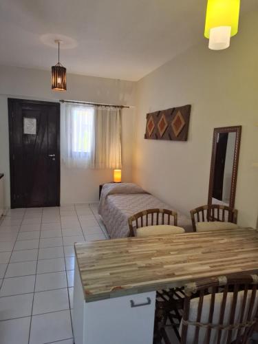 a bedroom with a bed and a table and chairs at Apart Hotel Serantes in Natal