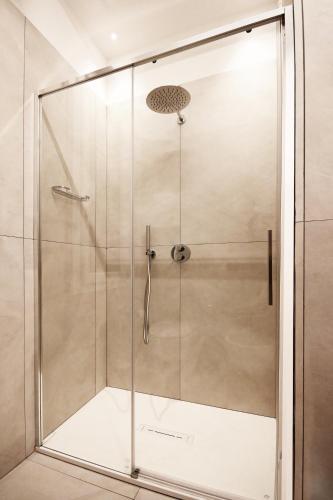 a shower with a glass door in a bathroom at La Casina di Luca in Rimini